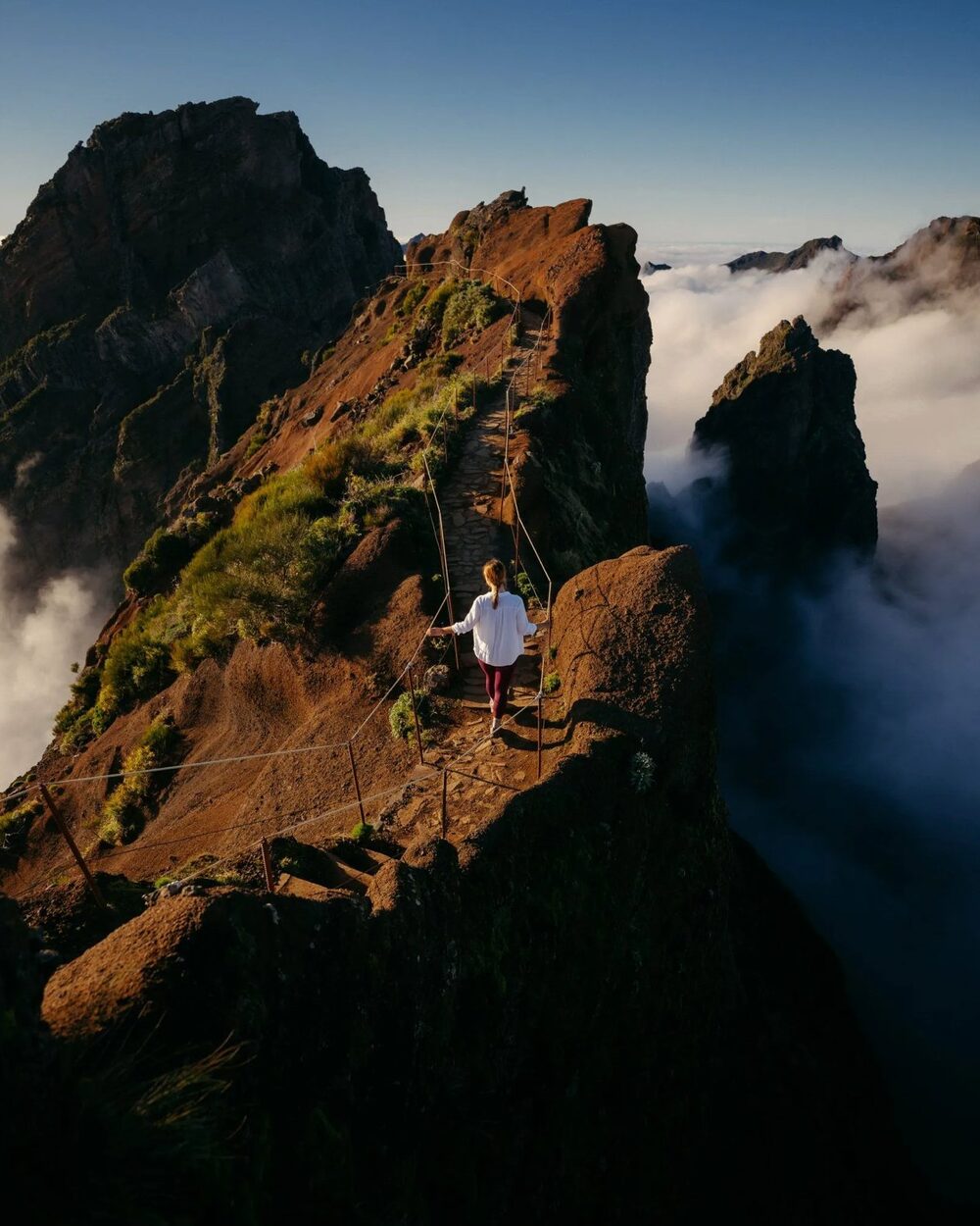 Hiker on the narrow ridge section of the PR1 trail